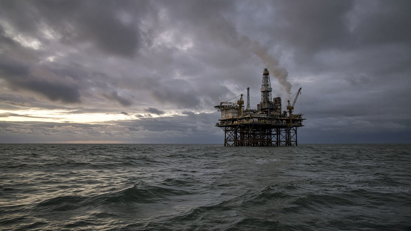 A North Sea energy platform at dusk on a grey sea