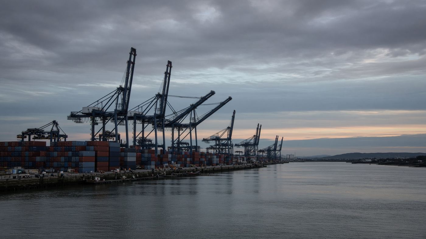 Cranes and containers at a British port at dusk